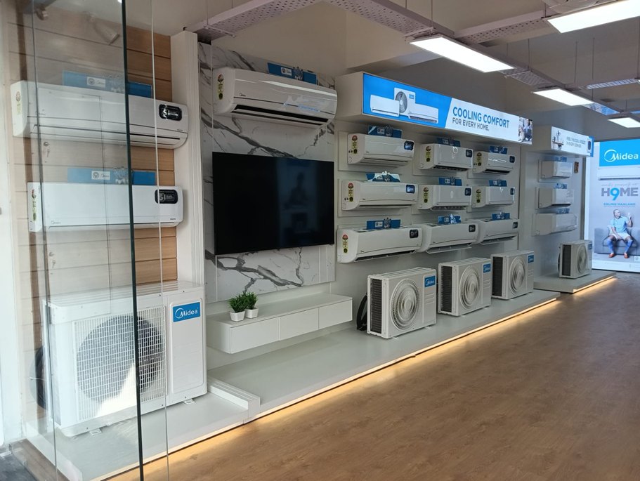 Appliance showroom with a product display wall and warm floor lighting
