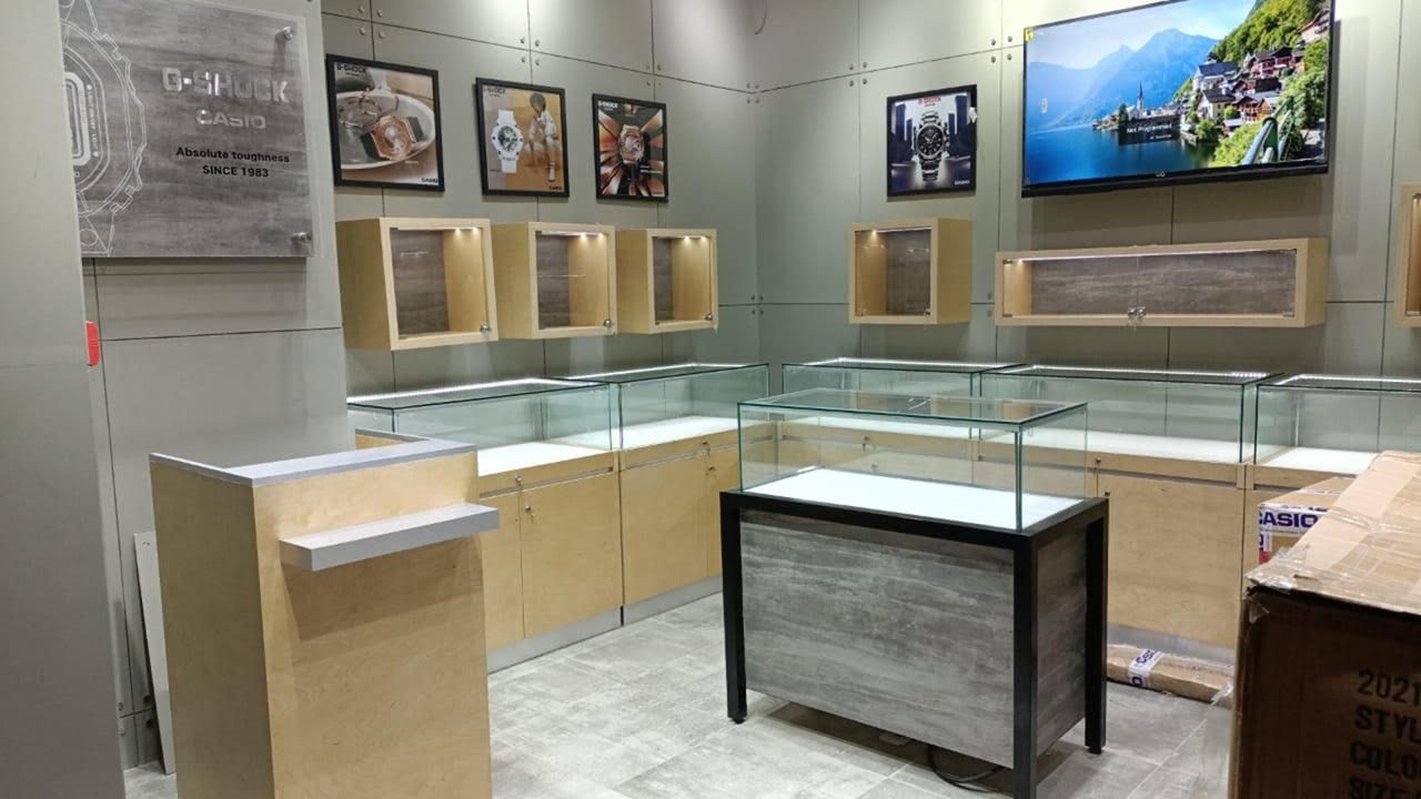 Retail store interior with glass display counters and timber-framed wall niches